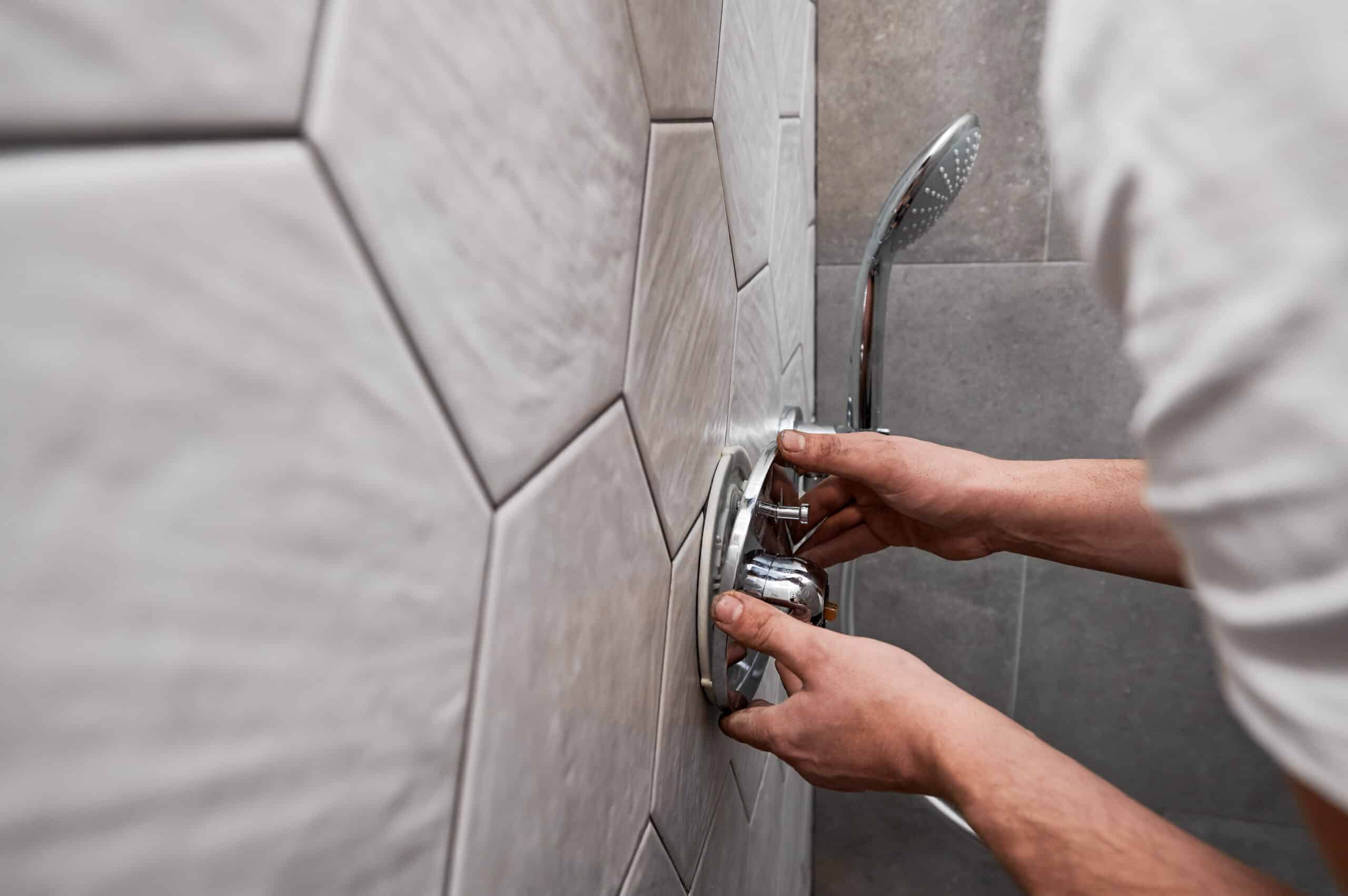American Energy Home Pros plumber installing a shower valve in Sacramento home