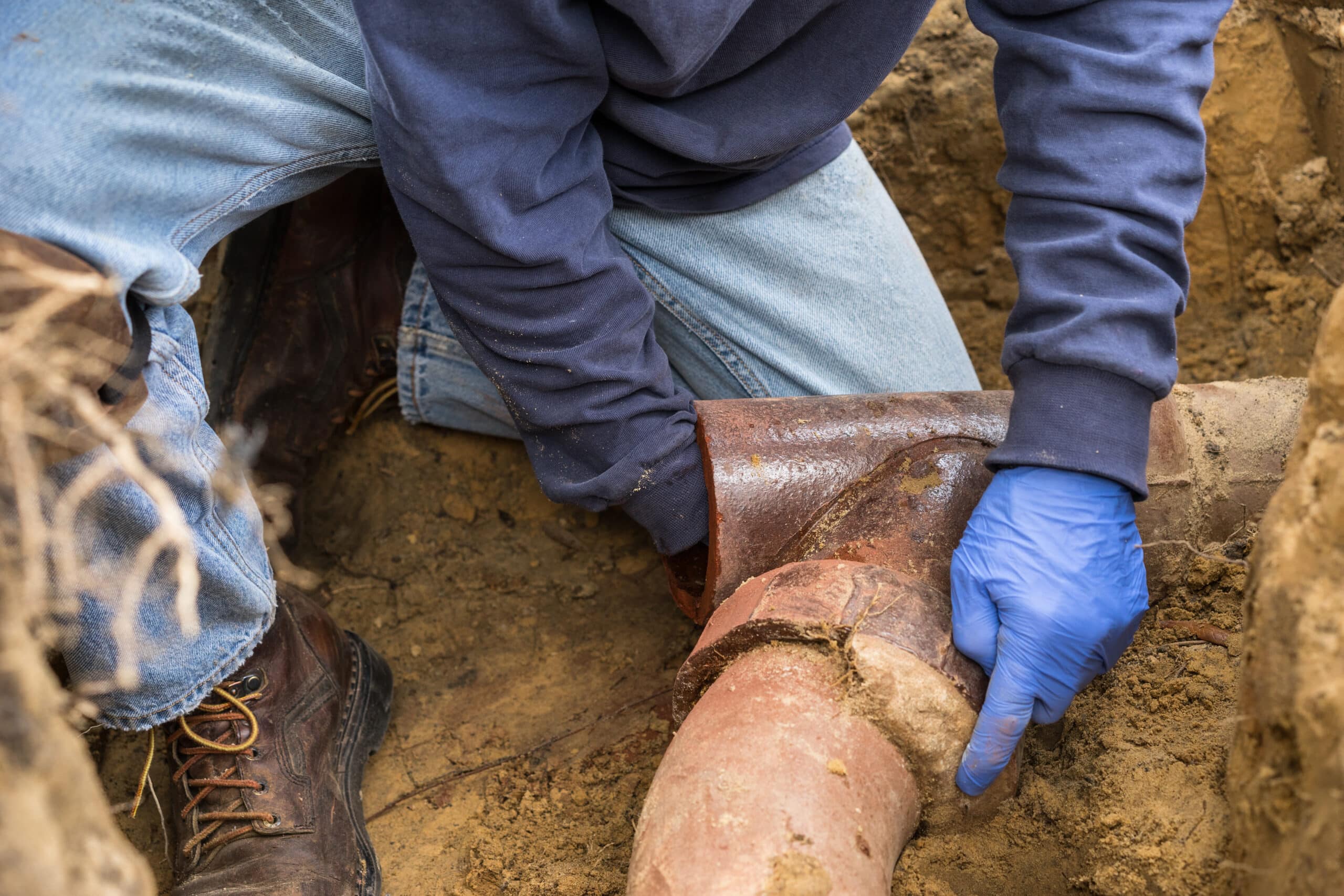 Plumber repairing underground water pipe in Sacramento