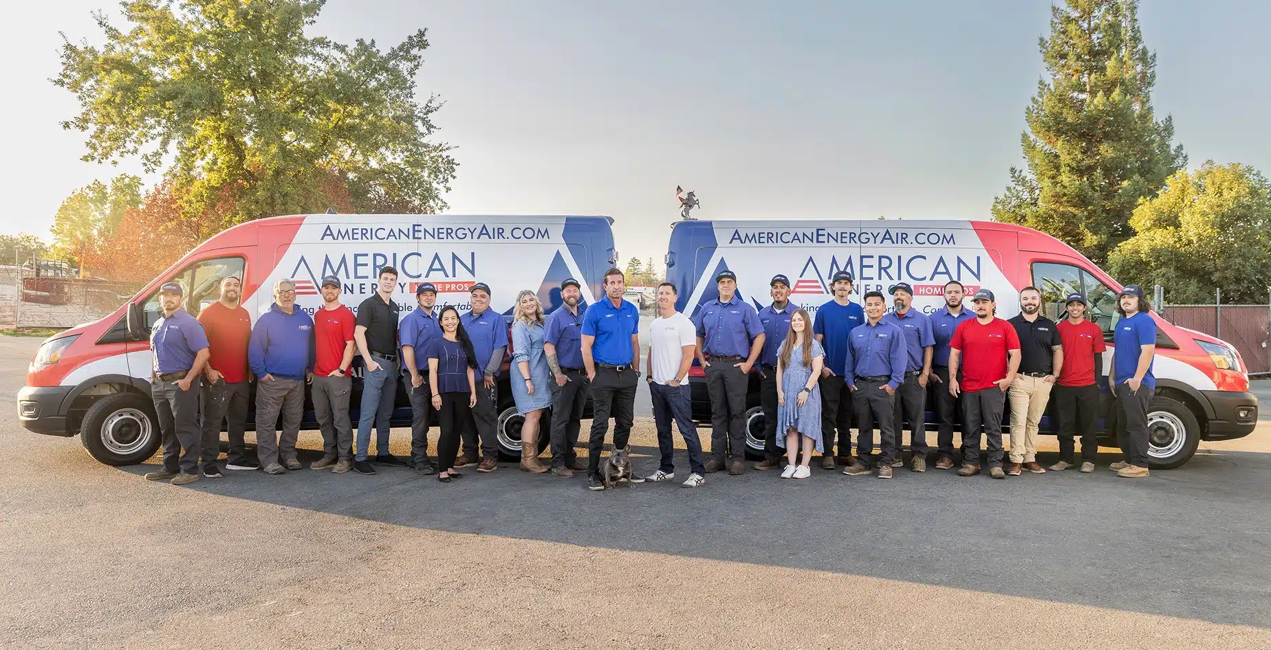 The American Energy Home Pros team and two service vans parked outside the Sacramento shop