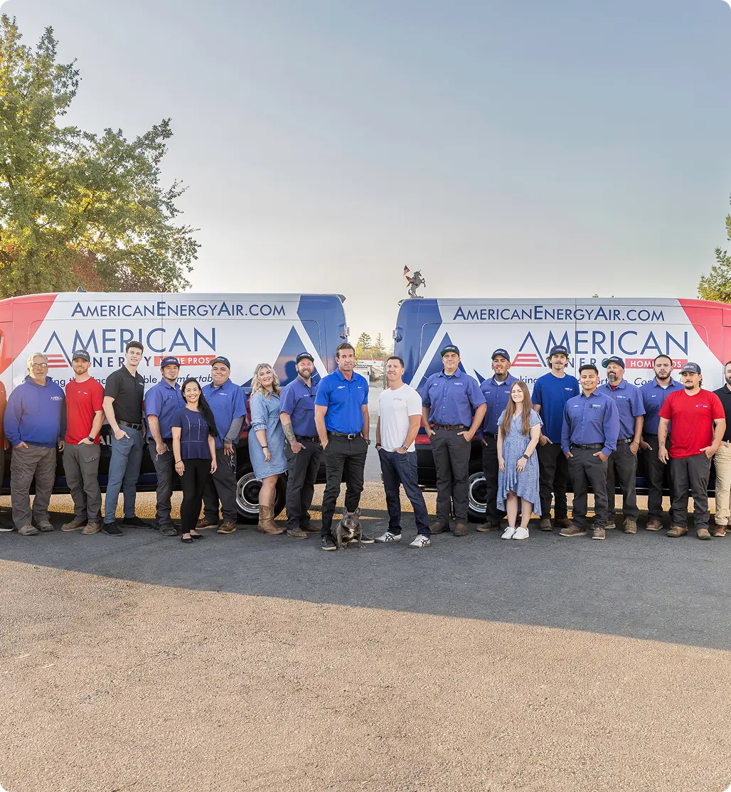 The American Energy Home Pros team standing in front of their branded service vans