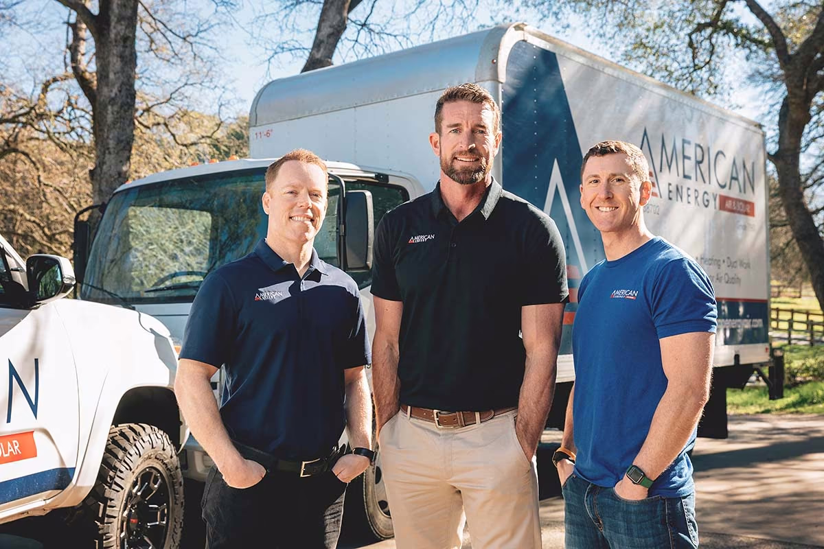 Three American Energy leaders standing in front of a company service truck