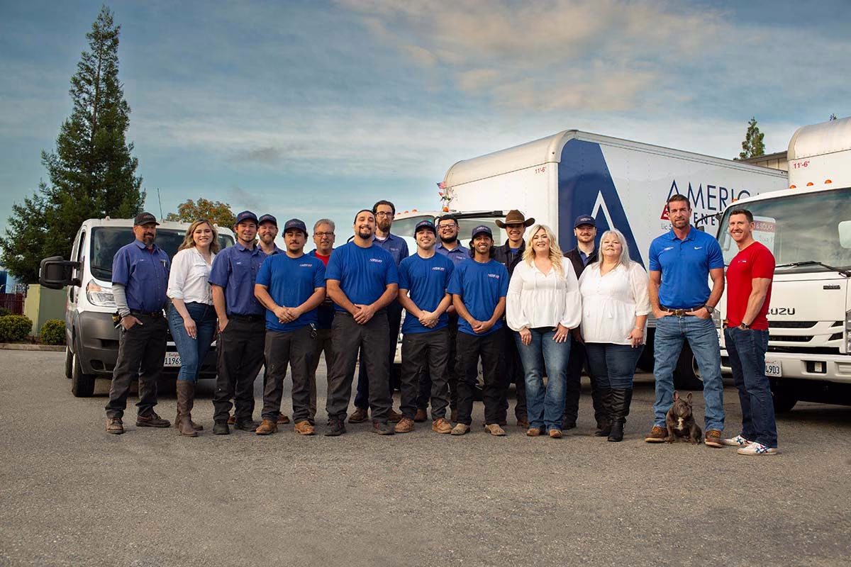 American Energy staff standing together in front of the company truck fleet