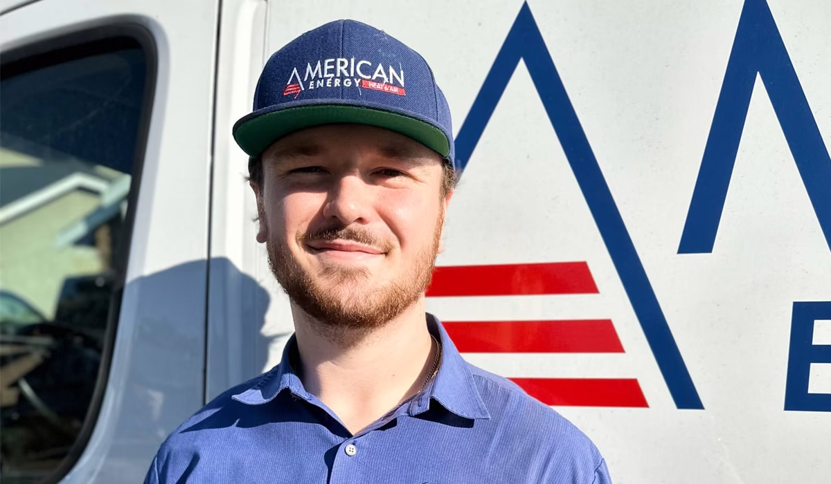 American Energy technician standing in front of a company service van