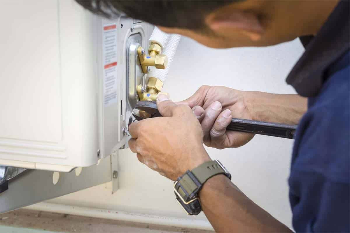 Technician opening a ductless mini split indoor head to make a repair