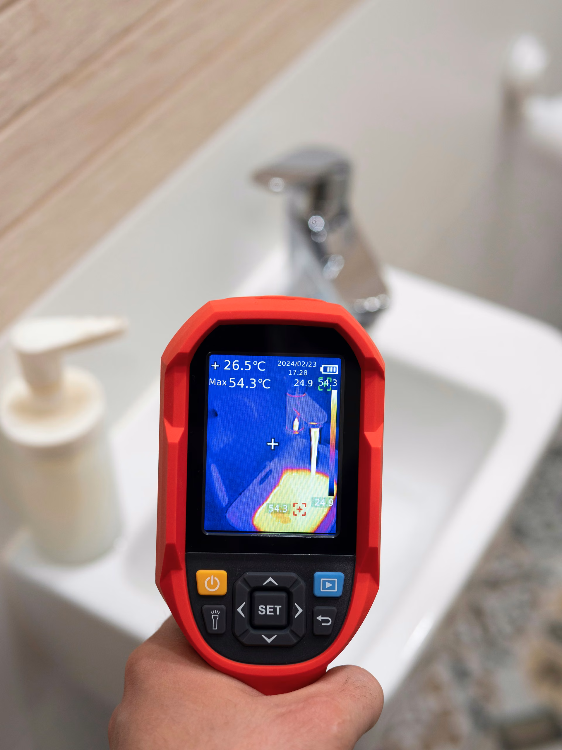 Thermal imaging camera used to find a hidden water leak near a sink