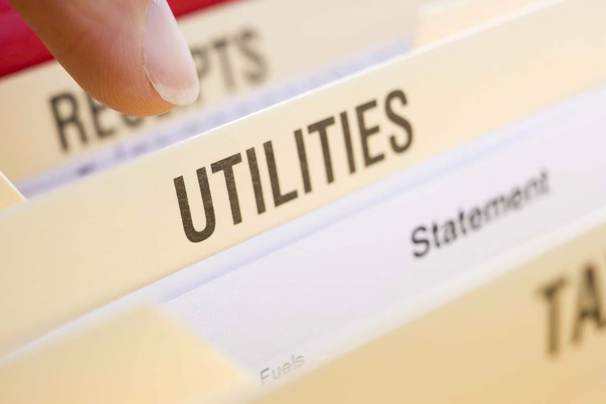 File folder tab labeled Utilities among household bill folders